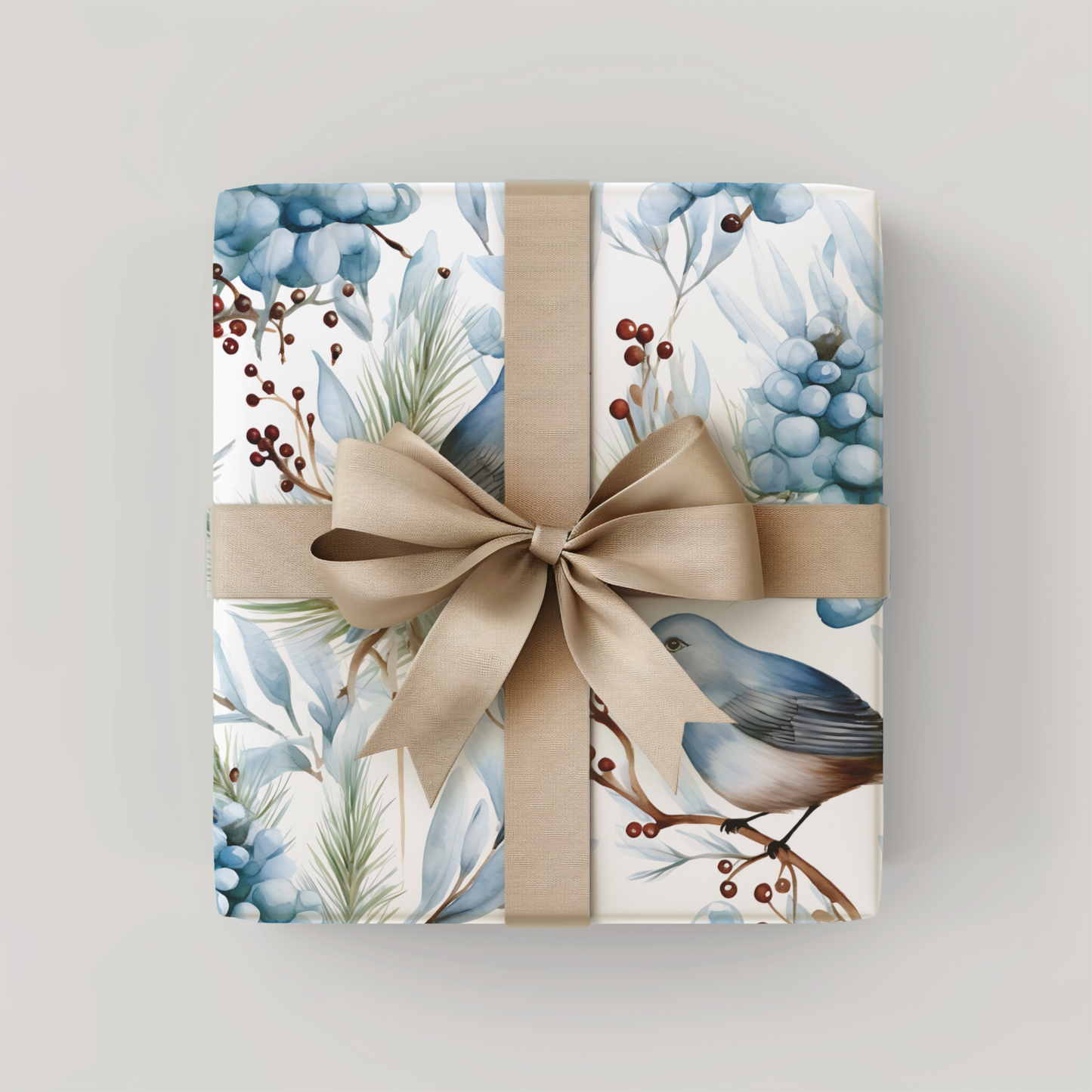 Gift box with floral design and beige ribbon on a light gray background