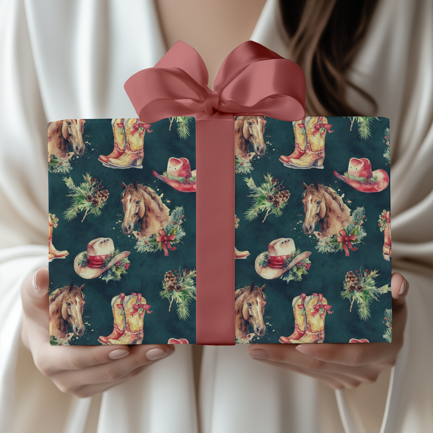 Gift box with cowboy boot and horse pattern and pink ribbon held by a person.