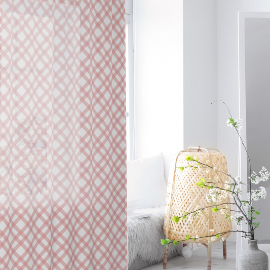 Pink geometric patterned curtain with a white interior room setting.