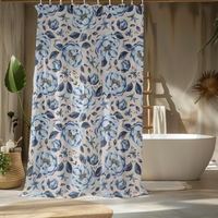 Floral patterned shower curtain in a bathroom setting with a bathtub and decor elements.