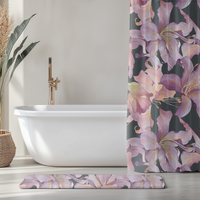 Bathroom with a freestanding bathtub, floral shower curtain, and matching rug.