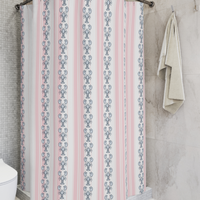 Shower curtain with lobster pattern on a striped background in a bathroom setting.