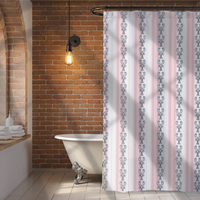 Bathroom with a patterned shower curtain, brick wall, and freestanding bathtub.