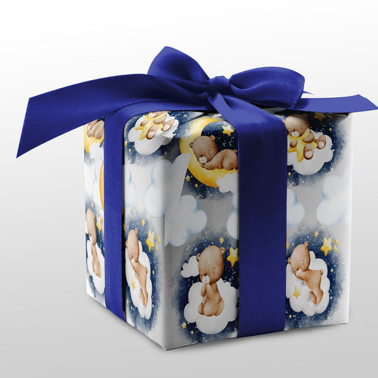 A baby shower gift wrap featuring a design with bears, moons, and stars on a blue ribbon.