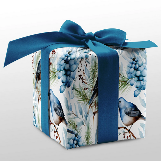 Gift box with blue ribbon and bird and berry pattern on a white background