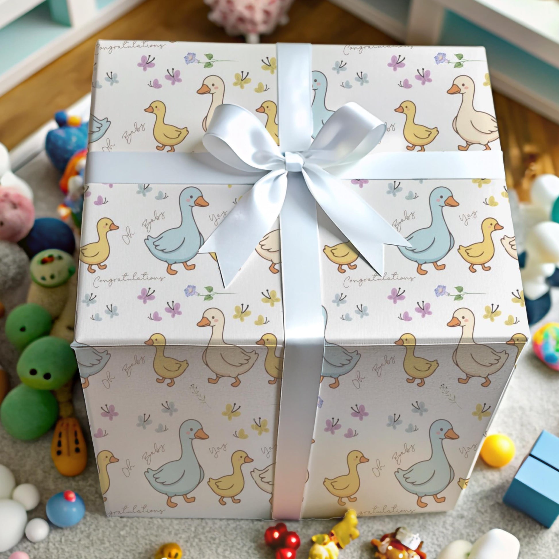 Cute duck baby shower wrapping paper with pastel ducklings and flowers wrapped around gift boxes