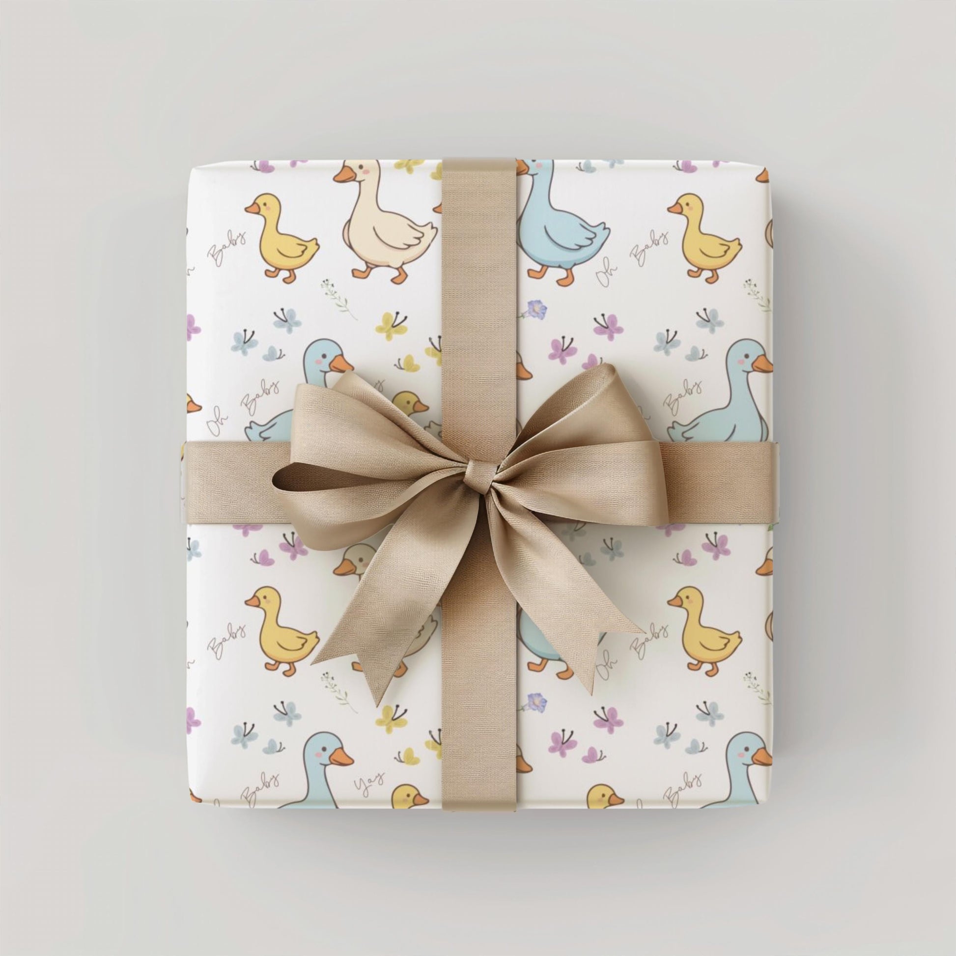 Cute duck baby shower wrapping paper with pastel ducklings and flowers wrapped around gift boxes